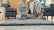 © tirachard - Close-up carpet. Happy Asian couple rolling out gray carpet relaxing smiling take a rest after moving stuff on living room at new house. Husband wife move house, Apartment Rent And Ownership Concept.