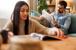 © Impact Photography - Couple reading newspapers and magazine while relaxing at home
