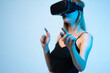 © Volodymyr_sh - Woman using virtual reality headset and touching virtual interface, immersive experience with copy space