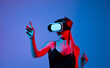 © Volodymyr_sh - Female user interacting with virtual reality interface using hand gestures, immersive VR experience, modern digital technology concept