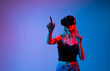 © Volodymyr_sh - Immersive virtual reality experience with woman using VR headset and hand gestures on gradient studio background