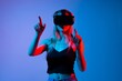 © Volodymyr_sh - Futuristic virtual interaction with woman wearing VR headset and controlling digital interface with hand gestures