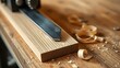 © Shylock - jointer. Close-up of a woodworking blade pressing against a wooden board, creating shavings. safety posters, maintenance manuals, designed for precision metalworking and fabrication facilities.