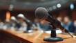© Jayk - Row of microphones on a wooden table in a conference room, ready for speakers