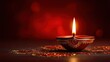 © Nurul - Lit clay lamp in ornate patterns & light scatters on dark reflective surface with a reddish background