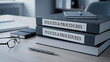 © Creative mind - A stack of policy and procedure books on a desk in an office setting.