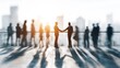 © Mia - Business agreement concept showing blurred silhouette of business people shaking hands near large window in office building showing blurry cityscape. High quality