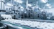 © Sim - A pharmaceutical manufacturing facility with a conveyor belt moving white pills.