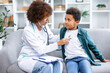 © Ivan - Multicultural female doctor checking child's lungs during medical checkup indoors. Obedient boy deeply breathing while pediatrician using stethoscope to examine respiratory organs of little patient