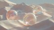 © CYBERPINK - Three soap bubbles floating on a sandy surface. the soap bubbles are of different sizes and shapes, with the largest one in the center and two smaller ones on either side.
