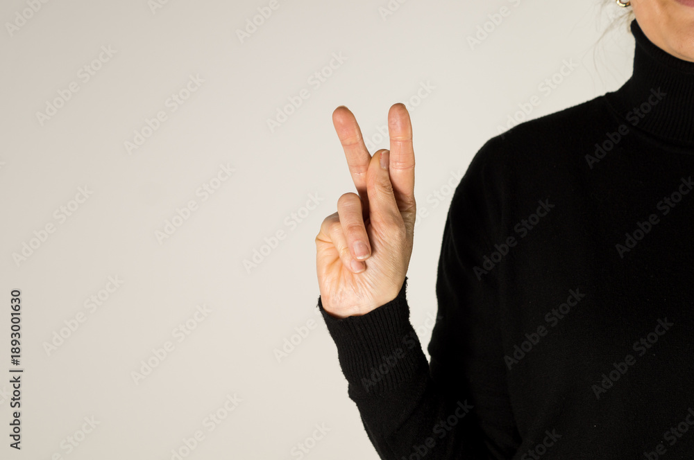 Hand signing the letter 'K' in ASL with the index and middle finger up ...