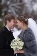 © New Africa - Happy newlywed couple with bouquet of flowers outdoors on winter day