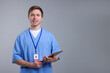 © New Africa - Portrait of medical assistant with tablet on grey background, space for text