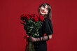 © New Africa - Valentine's day celebration. Woman with bouquet of roses on red background
