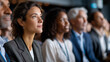© Laura - Diverse group of professionals in business attire attentively listening to presentation at conference, highlighting focus and engagement, business seminar scene, professional