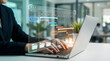 © merabbi - Person using a laptop to manage project phases and tasks on a digital Gantt chart, representing effective project planning and execution.