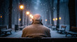 © Atmospheres - Lonely elderly man from behind sitting on a park bench during a snowy night, winter solitude and contemplation concept