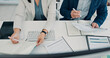 © SparkPix/peopleimages.com - Documents, above and hands of business people for finance report, budget review and research. Corporate, teamwork and man and woman with paperwork, financial proposal and writing notes for planning
