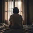 © Toni - Woman sitting on bed looking out window with curtains drawn in a serene morning atmosphere