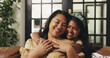 © peopleimages.com - Love, kid or mother with hug on sofa for bonding together, healthy relationship or protection. Happy family, mom or girl with embrace in home for connection, support or affection with care on weekend