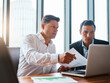 © BuyoutReese07/peopleimages.com - Business men, laptop and planning with document for finance, stock market analysis or meeting. Computer, team and talk with paperwork for investment, risk management and graphs for trading in office