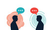 © Priya - Two male silhouettes facing each other with colorful speech bubbles representing conversation, dialogue, communication, or a business meeting.