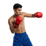 Shirtless boxer in red gloves throwing punch