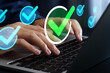 © tadamichi - Task completion and approval process. Automated request submission workflow. Checkmark icons. Businessman using laptop computer to manage tasks.