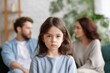 © Iryna - Young caucasian girl in focus with blurred parents arguing in background