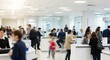 © Ilja - A Soft Focus Image of a Busy Banking Hall, Showcasing Clients Engaging with Tellers at Counters