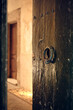 © Jacek - Old wooden door with metal knocker, rustic surface and weathered texture, evoking heritage, craftsmanship and timeless architecture.