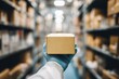 © PhotoProd - A person holds a box of medicine in a pharmacy. Shelves filled with boxes and bottles surround them in a clean setting