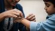 © VectorGenius - A woman gently ties a traditional bracelet on a young boy's wrist in a tender moment