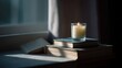 © Darya - Stack of books on a windowsill with a lit candle on top. the books are of different sizes and colors, with the largest one in the center and the smallest one on the bottom.
