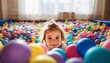 © Lightning - Adorable toddler peeking out from a colorful ball pit, full of joy and playfulness, perfect for childhood concepts, family life, and daycare advertisements