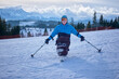 © Alex - A wheelchair user posing on alpine skis