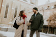© BGStock72 - Korean woman and Caucasian man walk and talk in a snowy city area on a winter day