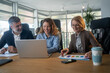 © Nenad - Casual meeting of smiling diverse business team analyzing financial data