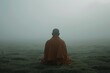 © nsit0108 - Monk meditating in foggy field, finding peace and mindfulness amidst nature's tranquility