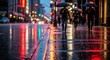 © joo - People with umbrellas walk along a wet city street at night illuminated by lights