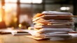© Muhammad - A large stack of paperwork sits on a wooden desk in a modern office space with natural light.