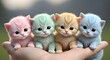 © Thahmidar - Four Adorable Fluffy Kittens in Pastel Colors Held Gently in Hand Outdoors