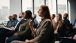 © DC Studio - Female participant raising hand and engaging in debate on microphone, attending corporate summit in conference hall with chairs and active audience. Diverse group at professional event.