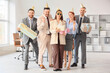 © Pixel-Shot - Group of funny business people with Birthday gifts in office
