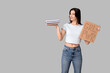 © Pixel-Shot - Young woman holding cardboard with text GRL PWR and books on grey background. Feminism concept