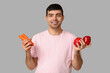 © Pixel-Shot - Young man with vegetables rich in vitamin A on light background