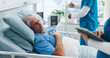 © Azeemud25/peopleimages.com - Nurse, tablet and senior man in hospital bed for surgery recovery, medical assessment or chest pain. Healthcare staff, old patient and professional with tech for checkup and angina healing discomfort