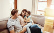 © peopleimages.com - Happy family, laughing or sofa with child for bonding, holiday or weekend break together in home. Mom, dad and relax with playful daughter or smile for fun childhood, parenting or funny joke in house