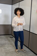 © wavebreak3 - African american woman standing in meeting room with whiteboard marker near panels on carpet