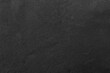 © peekeedee - Dark grey black slate background or texture.